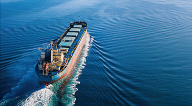 Merchant ship underway – illustration for Watermark maritime partners